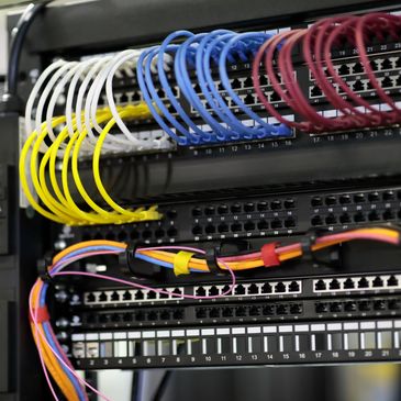 Color-coded network cables neatly connected to a server patch panel.