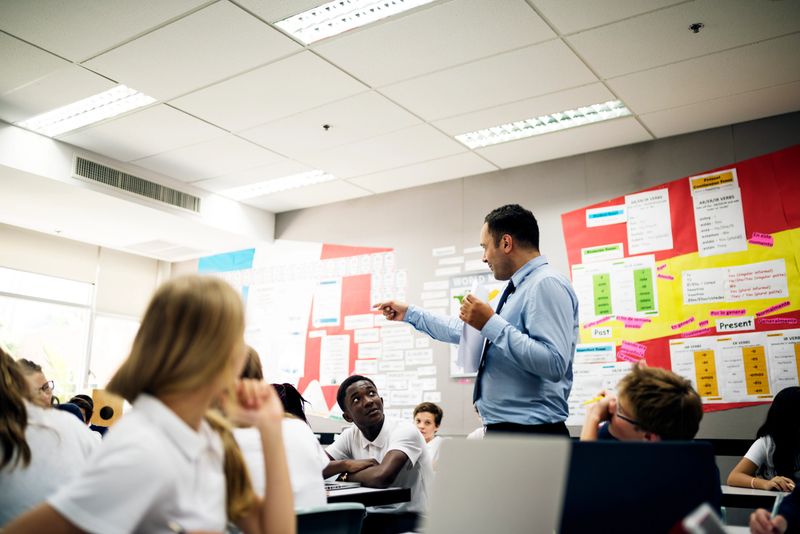 Students learning in a classroom with a teacher