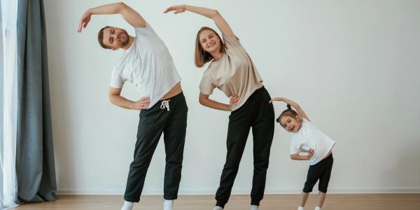 Family stretching exercises together at home.