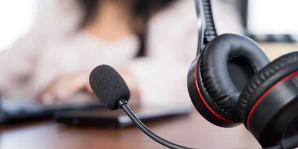 Close-up of a headset with a microphone on a desk.