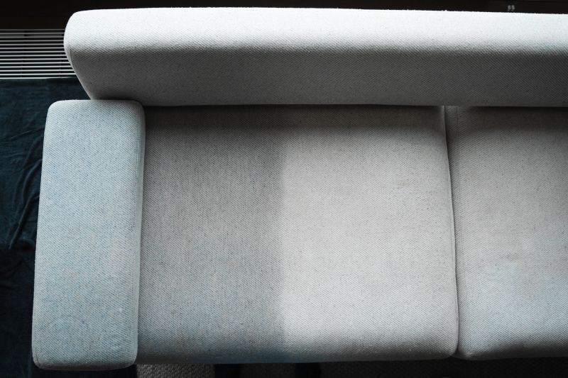 Before and after using extractor to refresh and clean from dust and stains upholstered furniture. Cleaner is dry-cleaning sofa using extractor machine with detergent