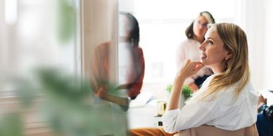 Woman thoughtfully listening during a meeting.