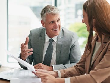 A man and woman smiling and talk to each other