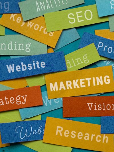 small pieces of paper showing: marketing, research, website, strategy, etc