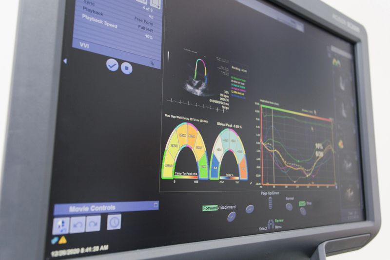 Medical professional performing an ultrasound examination on a patient using advanced equipment.Medical professional performing an ultrasound examination on a patient using advanced equipment.