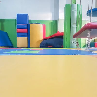 Colorful indoor gym mats and soft play equipment.