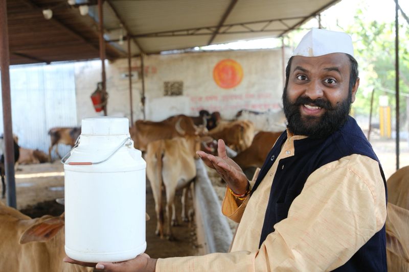 Young Indian Farmer and His Dairy Cows