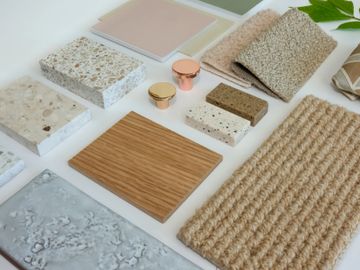 Assortment of textured and patterned material samples for interior design.
