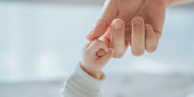 Mum and baby holding hands. Attachment, bond