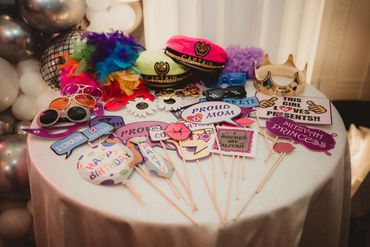 A table with colorful party props and accessories for a celebration.