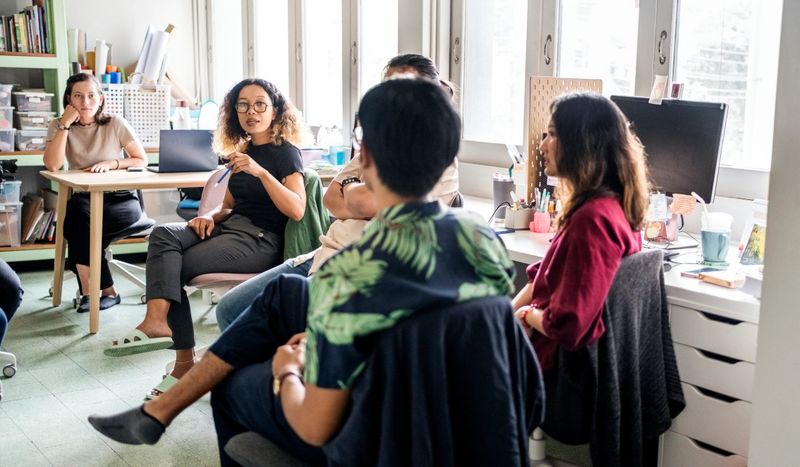 Team of businesspeople engaged in a discussion, working on a new project in non-profit organization office