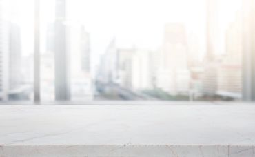 Empty concrete surface with city skyline in background.