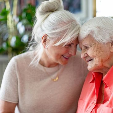 Mother and daughter smiling and forehead touching