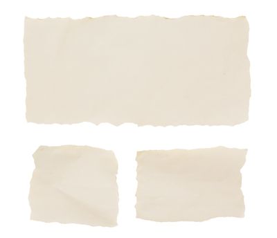 Three pieces of torn, blank beige paper on a white background.