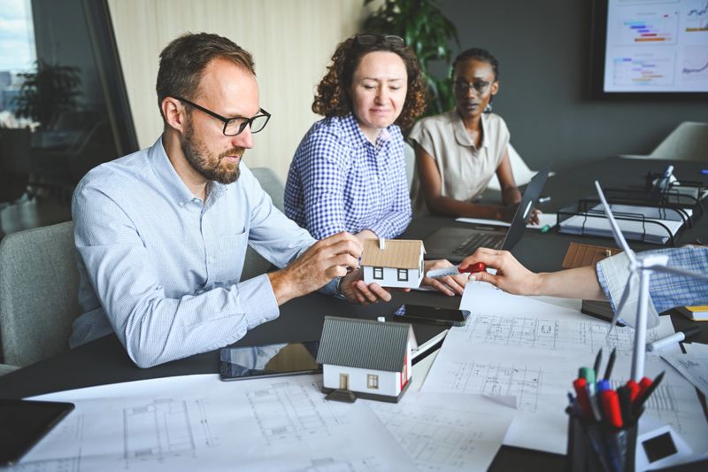 team of professionals discusses the construction of suburban housing and equipping it with alternative energy