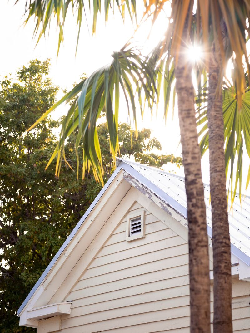 Tropical Yellow House with Palm Trees and sunburst in Key West, Florida