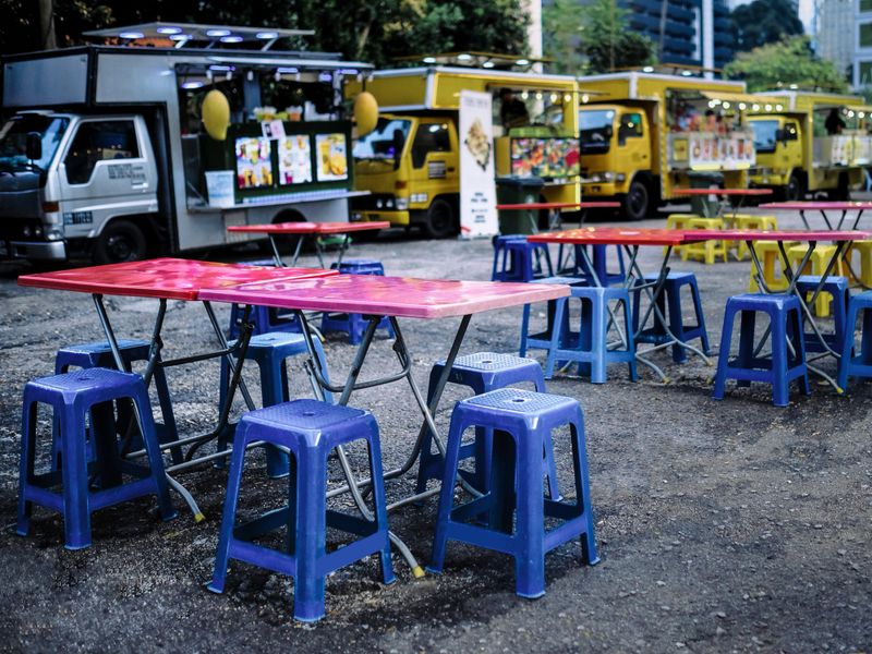 Low angle view of street food truck dining arae in the city