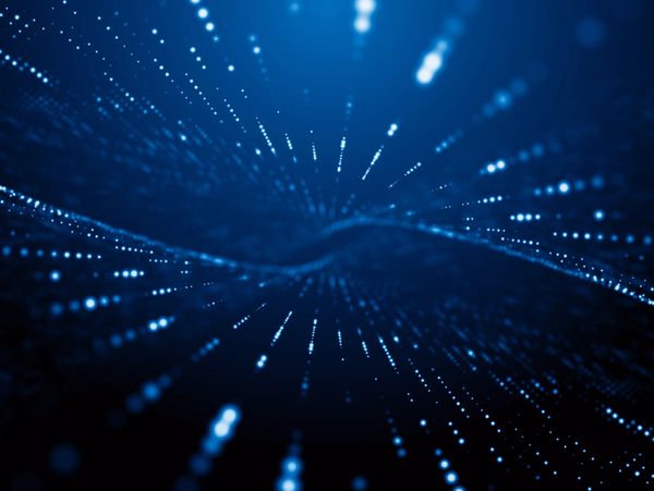 Abstract digital blue particles forming a wave-like pattern in space.