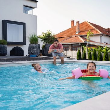 Caloundra  Happy family swimming in pool