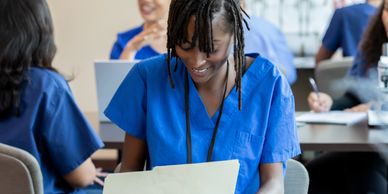 Nurse reviewing a document in a classroom.