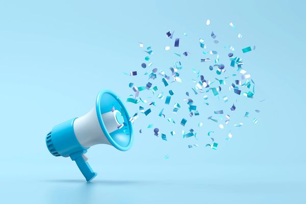 Blue megaphone with colorful confetti bursts on a light blue background.