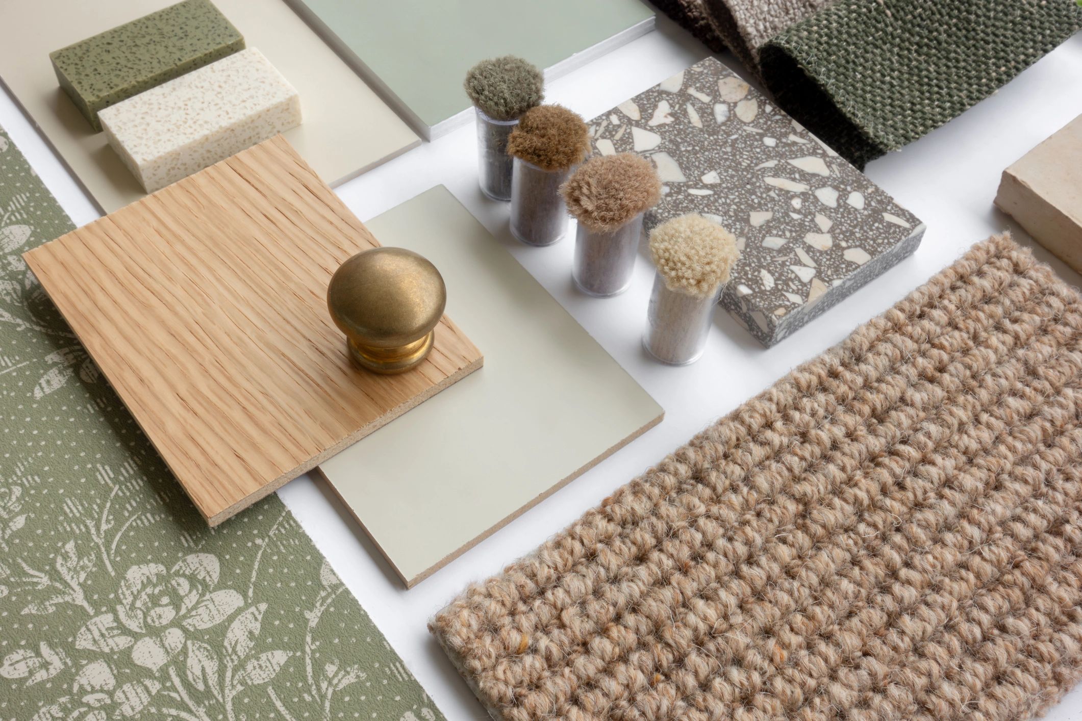 Aesthetic material samples including wood, fabric, tiles, and carpet swatches.