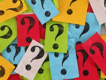 Colored boxes with question marks representing frequently asked questions for Cola Kids Consignment