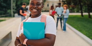 Happy black student holding blue folder
