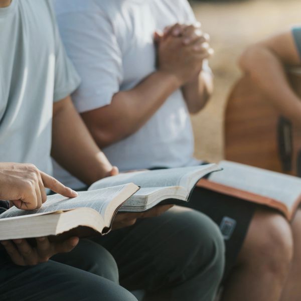People reading and praying with open books.