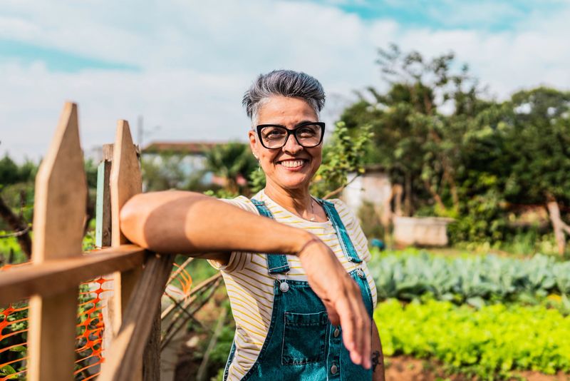 Portrait of a mature woman on a community garden  entrance
