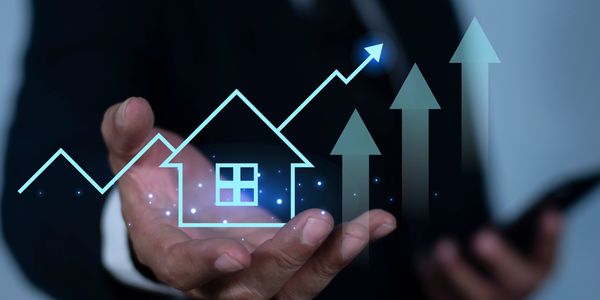 Hand holding digital real estate graph