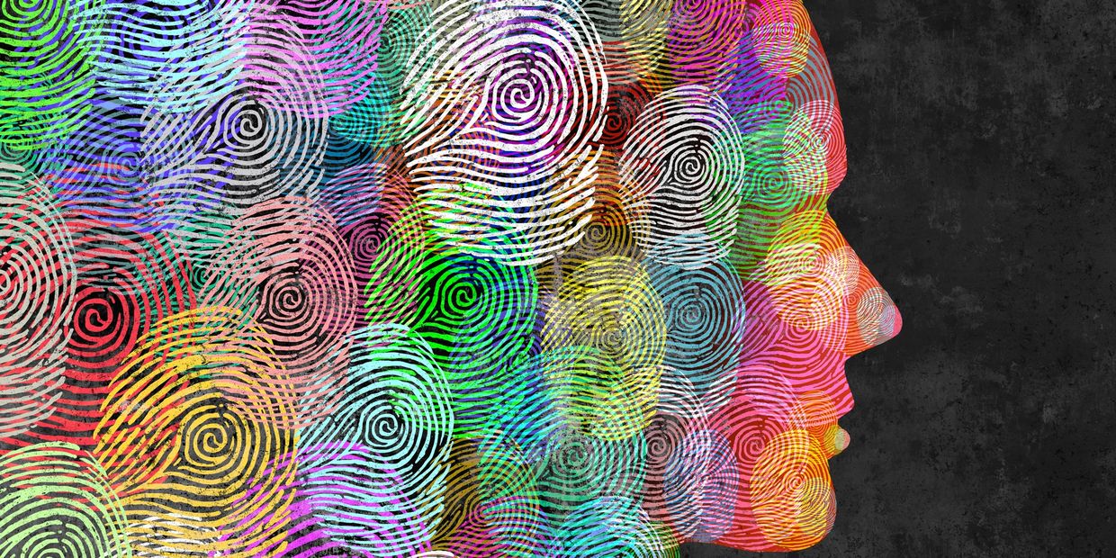 Colorful fingerprint patterns form a human face profile against a dark background.