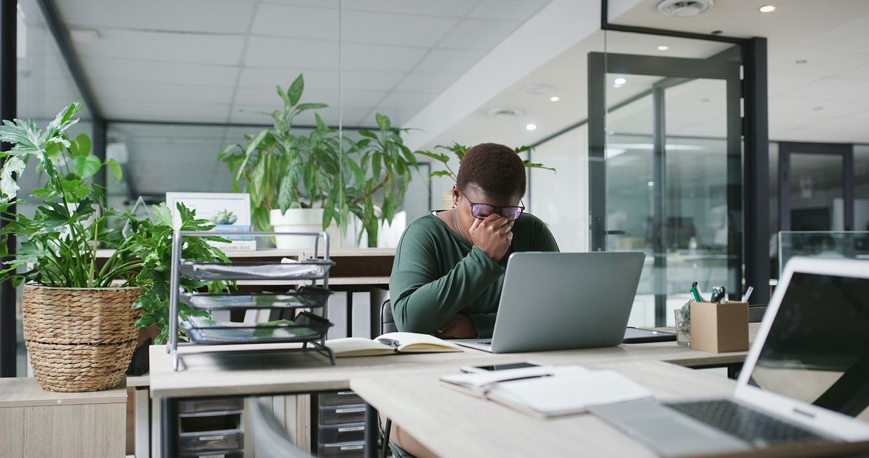 Adult experiencing focus difficulties in a modern office setting, representing ADHD symptoms in Balt