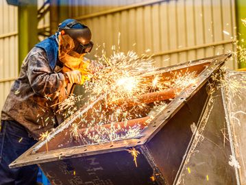A welder working with sparks flying.