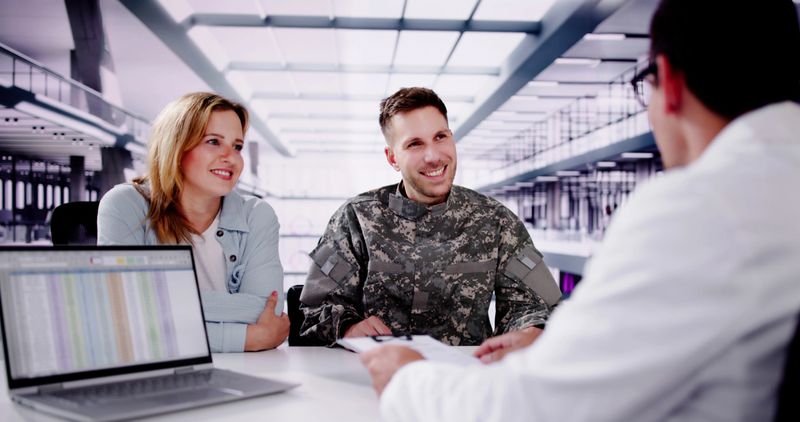 Dedicated Veteran Soldier Support: Military Doctor Providing Care to Hispanic Soldier in Uniform at Supportive Clinic