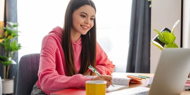 Student studying at home with a laptop, representing student mental health and balance