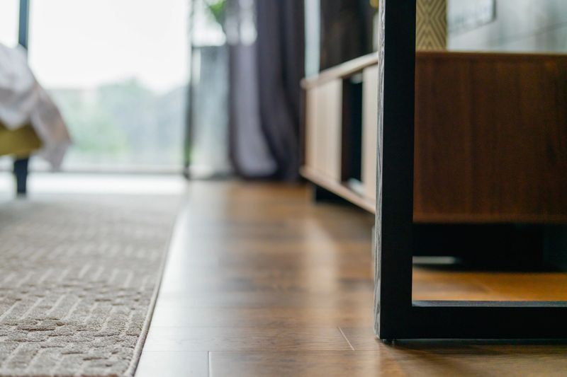 closeup bedroom furniture detail with bed and carpet rug floor in bedroom daylight house beautiful design concept