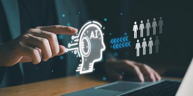 A glass monitor with a symbol of AI on a human brain image & someone's index finger pointing at it.