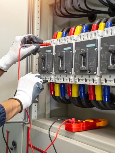 A rack with neatly arranged Ethernet cables or a technician connecting cables to a network switch.