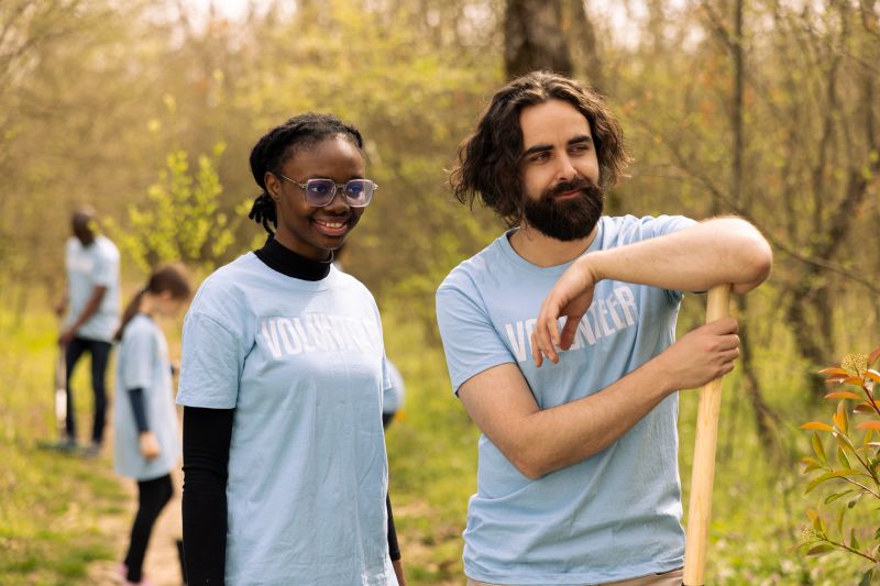 Portrait of diverse team of volunteers restoring forest habitat by planting seeds and growing trees, recycle garbage. Activists protecting wildlife and ecosystems, doing voluntary work.