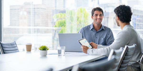 Two men having a business discussion in an office.