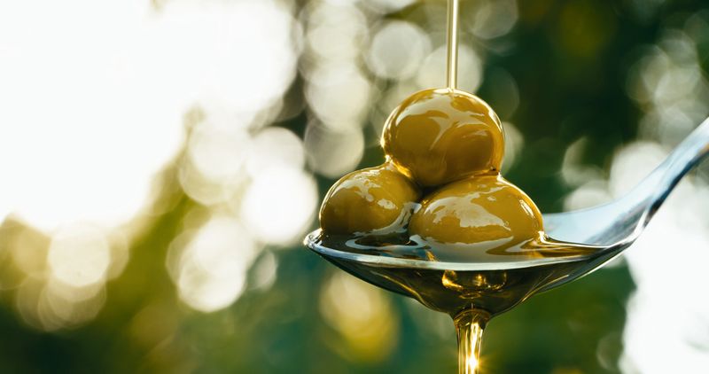 Green olive oil and olive oil concept