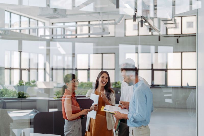 Photo of a multiracial group of people, coworkers in the same  company, participating in an unofficial meeting