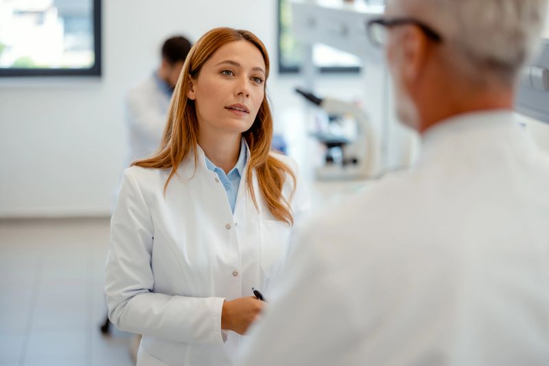 Modern Medical Research Laboratory: Portrait of Two Scientists Working, Talking. Advanced Scientific Pharmaceutical Lab for Medicine, Biotechnology Development