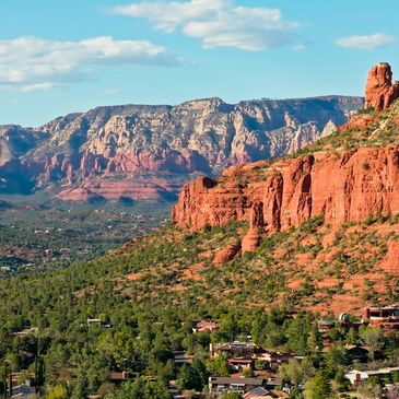 Scenic view of red rock formations and greenery in Sedona, Arizona.