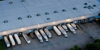 Trucks docked at a warehouse loading area.