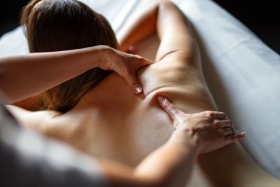 Person receiving a relaxing back massage.