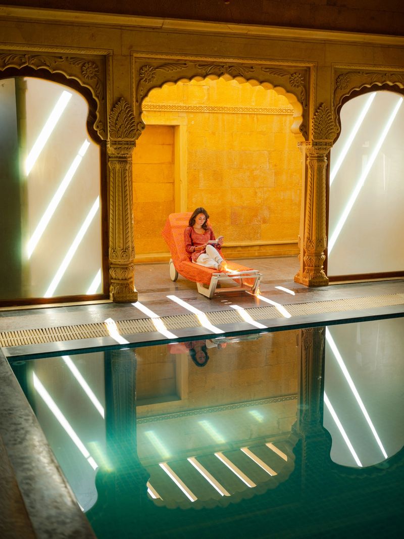 Woman reading engaging  book sitting on chair in haveli during trip