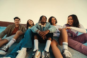Group of friends sitting and smiling together.