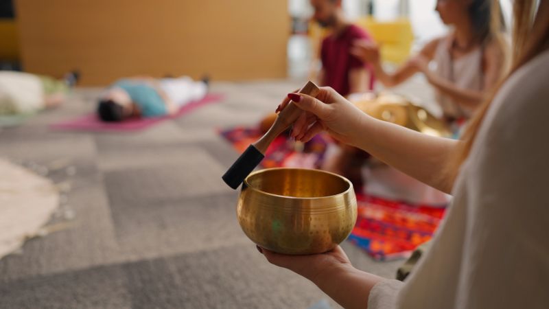 Performers and group of people are joining a music and sound therapy session.